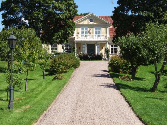 Tranberga s&auml;teri med stor huvudbyggnad och tv&aring; &auml;dre flyglar i rad. Gamla byn l&aring;g till v&auml;nster p&aring; bilden.  /Pr&auml;ster/